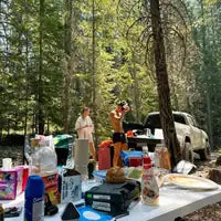Customer photo — camping vacation in the woods with the clip on the table